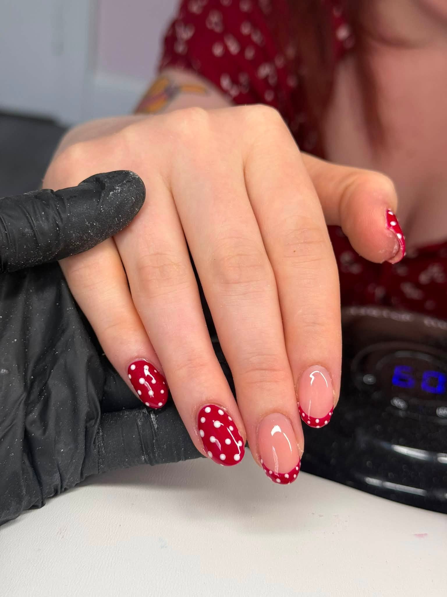 Deep red polka dot nail set with French tip accent